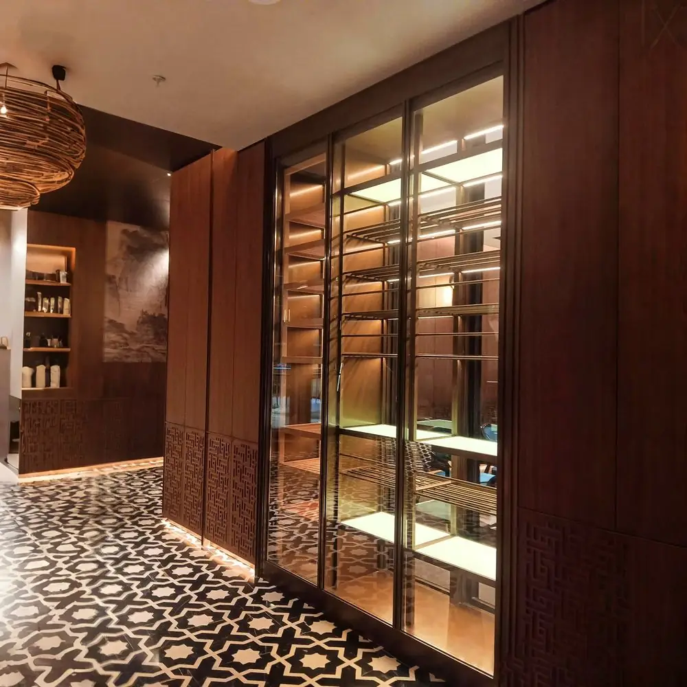 Built-In Corner Stainless Wine Display Cabinet — room setting with brick